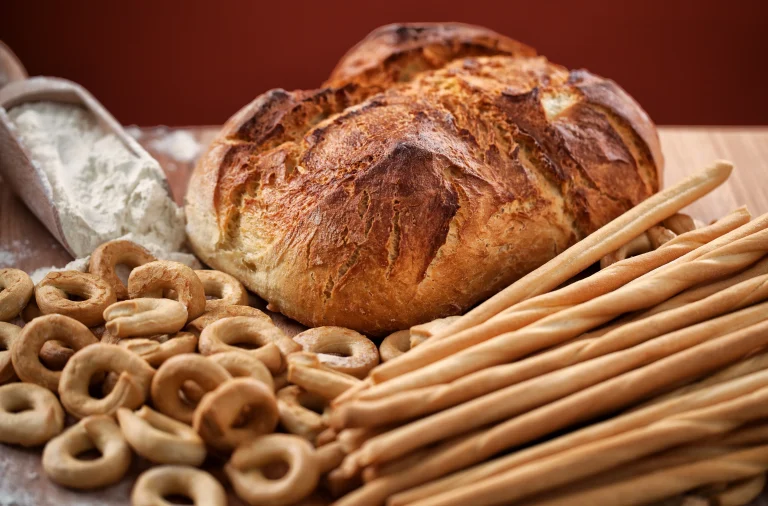 understanding carbohydrates: different types of breads on a wooden table representing starches